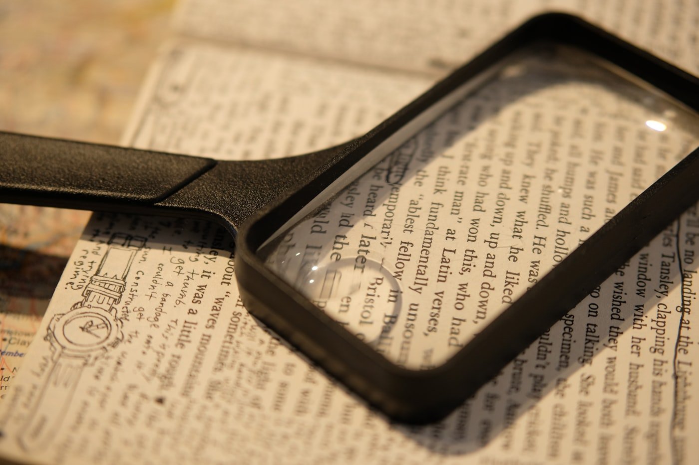 A magnifying glass resting on a page of printed text